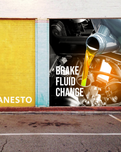 Create an image illustrating a mechanic changing brake fluid in a vehicle's brake system. The